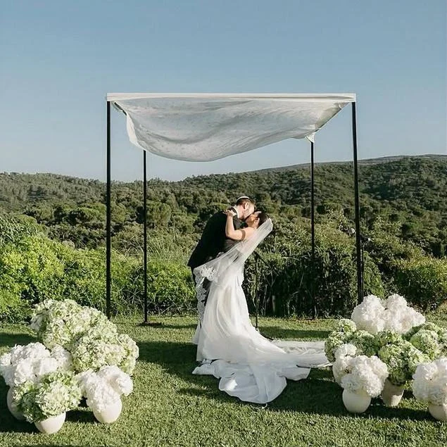 Jewish couple Liat and Ryan kissing under the chuppah during their destination wedding in Setúbal, Portugal, officiated by a Jewish ceremony expert.