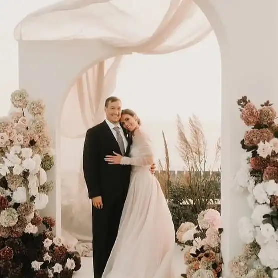 bride and groom, posing under a modern huppah during their Jewish wedding in Aethos Ericeira, Portugal