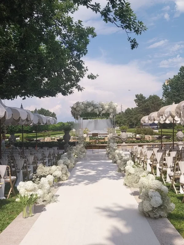 Elegant white floral chuppah and wedding aisle at Solar da Levada, Portugal.