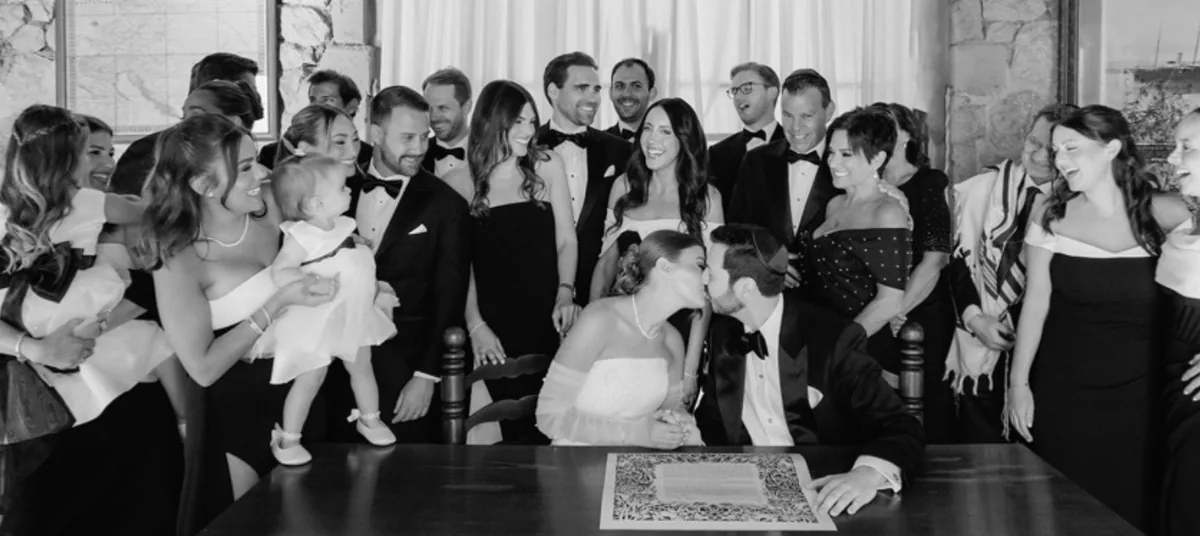Ketubah signing at a Jewish wedding in Mallorca, with the bride and groom surrounded by family and friends